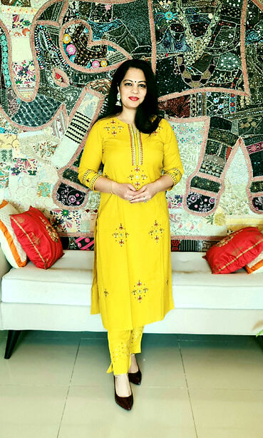 Mustard yellow kurta set with embroidery motifs on kurta and smart pants with details at cuts