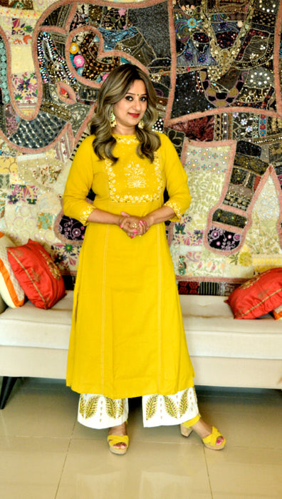 Canary yellow kurta with embroidery at yoke paired with off white palazzo pants having patchwork